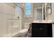 Bathroom with tile shower, sleek vanity, modern fixtures, and plantation shutters at 754 Agate Hills St, Las Vegas, NV 89138