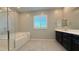 Modern bathroom with a glass-enclosed shower, soaking tub, and double vanity at 754 Agate Hills St, Las Vegas, NV 89138