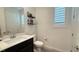 Bright bathroom with white vanity, shuttered windows, and modern fixtures at 754 Agate Hills St, Las Vegas, NV 89138