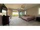 Spacious bedroom with a ceiling fan, TV, closet and sliding doors to an outdoor balcony at 754 Agate Hills St, Las Vegas, NV 89138