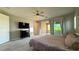 Large bedroom featuring a ceiling fan, TV, dresser, and outdoor balcony access at 754 Agate Hills St, Las Vegas, NV 89138