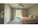 Bright bedroom featuring a ceiling fan, neutral tones, and sliding glass doors to the outdoor space at 754 Agate Hills St, Las Vegas, NV 89138
