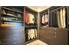 Organized walk-in closet with shelves, drawers, and hanging rods, perfect for wardrobe storage at 754 Agate Hills St, Las Vegas, NV 89138