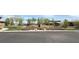 View of the community landscaping and walking path, featuring lush greenery and colorful flowering plants at 754 Agate Hills St, Las Vegas, NV 89138