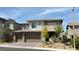 Modern two-story home with a three car garage, neutral color scheme, and low maintenance landscaping at 754 Agate Hills St, Las Vegas, NV 89138