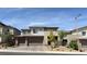 Exterior view of a home with a three-car garage and landscaped front yard at 754 Agate Hills St, Las Vegas, NV 89138