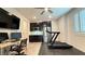 Home gym area featuring a treadmill, desk area, mini bar, and dark cabinetry at 754 Agate Hills St, Las Vegas, NV 89138
