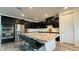 Well-equipped kitchen with stainless appliances, granite counters, island seating and dark cabinets at 754 Agate Hills St, Las Vegas, NV 89138