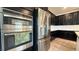 Contemporary kitchen with stainless steel appliances and dark cabinets exudes modern elegance at 754 Agate Hills St, Las Vegas, NV 89138
