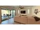 Comfortable living room featuring a large sectional sofa, patio access, and bright lighting at 754 Agate Hills St, Las Vegas, NV 89138
