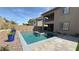 A stunning backyard with a sparkling pool, spa, and well-designed landscaping create an outdoor oasis at 754 Agate Hills St, Las Vegas, NV 89138