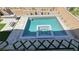 Aerial view of a custom pool with a spa, modern landscaping, and outdoor kitchen at 754 Agate Hills St, Las Vegas, NV 89138