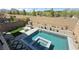 Backyard oasis featuring a modern pool, attached hot tub, built-in grill and lush landscaping at 754 Agate Hills St, Las Vegas, NV 89138