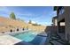 Beautiful pool and spa area with brick retaining wall, lush landscaping, and patio at 754 Agate Hills St, Las Vegas, NV 89138