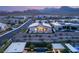Twilight aerial shot of backyard featuring pool, landscaping, and mountain views at 826 Bolide St, Las Vegas, NV 89138
