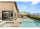 Beautiful backyard with a sparkling pool, lounge chairs, and outdoor kitchen at 826 Bolide St, Las Vegas, NV 89138