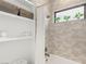 Contemporary bathroom with shower, tub, built-in shelves, and small plants at the window at 826 Bolide St, Las Vegas, NV 89138