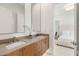 Clean bathroom with a double sink vanity and modern fixtures with view into the bedroom at 826 Bolide St, Las Vegas, NV 89138