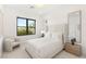 Bright bedroom featuring a tall headboard, large window, and full-length mirror at 826 Bolide St, Las Vegas, NV 89138