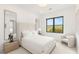 Bright bedroom featuring a tall headboard, large window, and full-length mirror at 826 Bolide St, Las Vegas, NV 89138