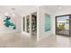Bright foyer featuring tile flooring, modern artwork, and an open doorway, creating an inviting entrance at 826 Bolide St, Las Vegas, NV 89138