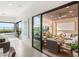 A bright hallway leading to an outdoor patio with comfortable seating and a pool at 826 Bolide St, Las Vegas, NV 89138