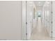 Bright hallway with white walls and doors, leading to the outdoor living area at 826 Bolide St, Las Vegas, NV 89138