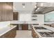 Bright kitchen featuring a large island with cooktop, stainless steel appliances, and white countertops at 826 Bolide St, Las Vegas, NV 89138