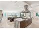 Open kitchen showcasing a center island with cooktop, stainless steel hood, and seamless flow into the living area at 826 Bolide St, Las Vegas, NV 89138