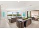 Spacious living and dining area featuring large windows, modern furnishings, and access to an outdoor pool at 826 Bolide St, Las Vegas, NV 89138