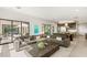 Open living area with large sectional and views of the outdoor living space with pool at 826 Bolide St, Las Vegas, NV 89138
