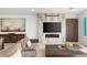 Cozy living room featuring a modern fireplace, a large TV, comfortable seating, and stylish decor at 826 Bolide St, Las Vegas, NV 89138