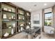 Home office with custom built-ins, modern desk, and comfortable seating area at 826 Bolide St, Las Vegas, NV 89138
