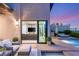 Elegant outdoor space with a cozy seating area that offers access to the pool and patio at 826 Bolide St, Las Vegas, NV 89138