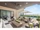 Covered patio with elegant seating, ceiling fan, overlooking a pool and landscaped backyard at 826 Bolide St, Las Vegas, NV 89138