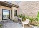Stylish patio area with modern seating and textured stone wall, perfect for outdoor relaxation and curb appeal at 826 Bolide St, Las Vegas, NV 89138