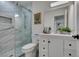 Modern bathroom featuring marble tiled shower with glass door, sleek white vanity, and stylish fixtures for a spa-like experience at 8640 Trafalgar Dr, Las Vegas, NV 89117