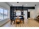 Dining area with hardwood floors, stylish lighting, and built-in shelving with kitchen view at 8640 Trafalgar Dr, Las Vegas, NV 89117
