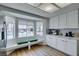Bright kitchen featuring stainless steel appliances, white cabinets, a breakfast nook with bay window, and wood floors at 8640 Trafalgar Dr, Las Vegas, NV 89117