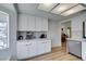 Bright kitchen with white cabinets, stainless steel appliances, and light wood flooring, creating a clean and modern space at 8640 Trafalgar Dr, Las Vegas, NV 89117