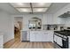 Modern kitchen with stainless steel appliances, white cabinets and quartz countertops at 8640 Trafalgar Dr, Las Vegas, NV 89117