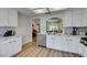 Bright kitchen with white cabinets, stainless steel appliances, and light wood flooring, creating a clean and modern space at 8640 Trafalgar Dr, Las Vegas, NV 89117