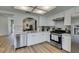 Bright kitchen featuring stainless steel appliances, white cabinets, quartz countertops, and a stainless steel range at 8640 Trafalgar Dr, Las Vegas, NV 89117