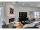 Bright open living space with a modern fireplace, sleek TV, and comfortable seating area at 8640 Trafalgar Dr, Las Vegas, NV 89117