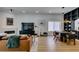 Modern living room with hardwood floors, a leather sofa, fireplace, and a dark dining set at 8640 Trafalgar Dr, Las Vegas, NV 89117