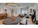 Bright living room features a decorative fireplace, modern lighting, and access to other rooms at 8640 Trafalgar Dr, Las Vegas, NV 89117