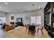 Open concept living room featuring a decorative fireplace, modern lighting, and wood-look floors at 8640 Trafalgar Dr, Las Vegas, NV 89117