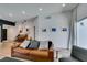 Bright living room with a leather sofa, and view of the front door and natural light at 8640 Trafalgar Dr, Las Vegas, NV 89117
