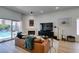 Bright living room with modern furniture, fireplace, and sliding glass door to pool area at 8640 Trafalgar Dr, Las Vegas, NV 89117