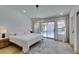 Bright main bedroom with white walls, a large rug, and sliding doors that lead to an outdoor swimming pool at 8640 Trafalgar Dr, Las Vegas, NV 89117